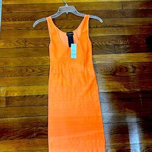 A beautiful dress with some of the back out like a circle.